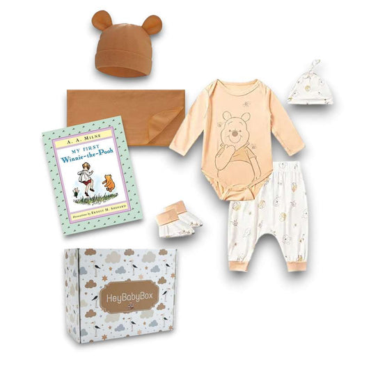 Winnie the Pooh clothing and accessories set with a book on a white background