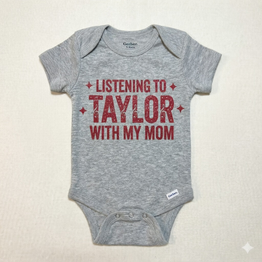 Gray baby onesie with red text 'Listening to Taylor with my mom' on a beige background