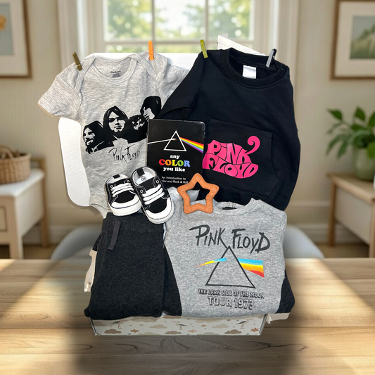 Collection of Pink Floyd-themed clothing and accessories on a table with a home interior background.